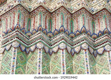Close up beauitful mosaic tiles or colorful floral pattern decor on stupas in Wat Pho, temple in Bangkok, Thailand. Handmade or craft vintage styles.