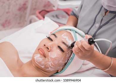 Close Up Of Beautician Hand Doing Beauty Treatment Procedure Using Special RF Or Radio Frequency Equipment