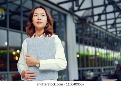 Close Up Beautiful Asian Businesswoman Holding Resume Folder At Outside Company Building For Looking Job Interview Concept