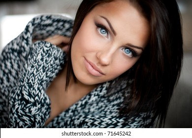 Close up of a beautiful blue-eyed girl in warm sweater