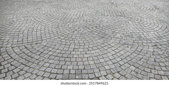 Close up of a beautiful cobblestone floor with a circular pattern - Powered by Shutterstock