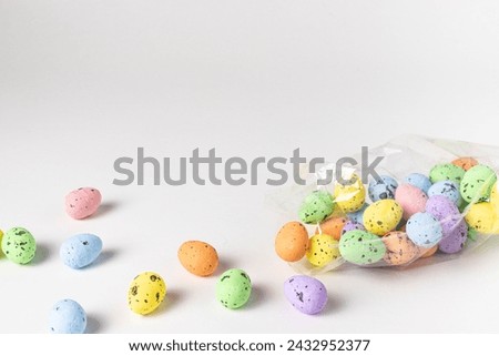 Close up of beautiful colorful easter eggs from plastic bag on white background. Holiday concept.