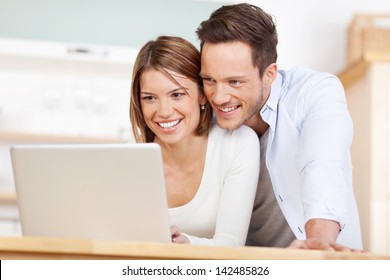 Close up beautiful couple working on laptop at home