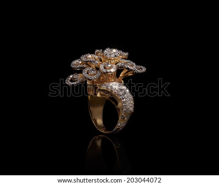 close up of beautiful diamond ring , with many different precious gemstone over background  