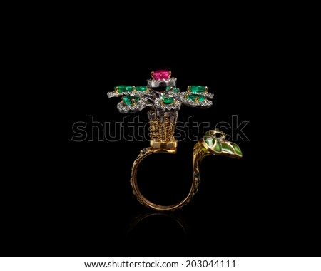 close up of beautiful diamond ring , with many different precious gemstone over background  