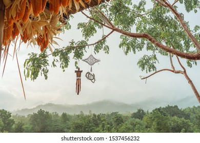 Close Up Beautiful Dream Catcher Mobile Hanging On The Tree With Beautiful Mountain View In The Morning Fog.