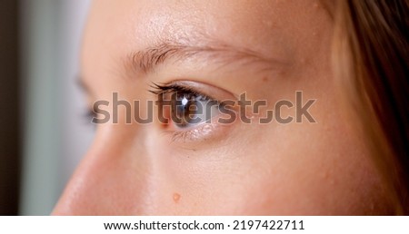 Close up beautiful eyes of young woman looking forward, Female eyes with eyelashes close up shot