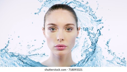 Close Up Of A Beautiful Face Of A Woman Without Imperfections, Wrinkles And Greasy Skin, In Short A Perfect Skin Thanks To The Creams And Detergents Represented With The Water In Front Of Her Face.