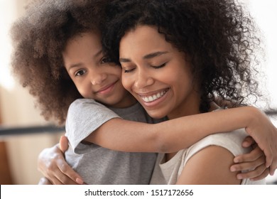 Close Up Beautiful Faces Happy Family Portrait Loving African Daughter Hugs Mother, Mom Enjoy Moment Of Tenderness Closed Eyes Feels Deep Love To Her Pretty Kid, Adoption Protection Offspring Concept