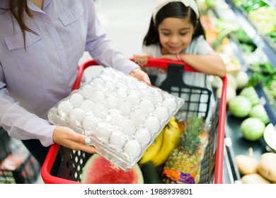 Close Up Of A Beautiful Family Buying A Lot Of Eggs, Fruits, Vegetables And Fresh Products In The Shopping Cart At The Grocery Store