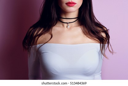 Close up of beautiful fashion young woman with black choker pearl on her neck