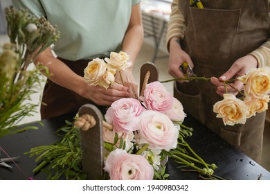 Close up of beautiful flower composition with roses and peonies on table in florist workshop, copy space - Powered by Shutterstock