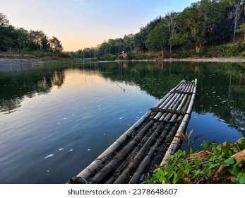 Close up of beautiful lanscape, bamboo raft on a river with nature reflection