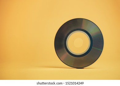 Close Up Beautiful Old Mini Disk On Yellow Background.