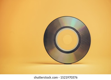 Close Up Beautiful Old Mini Disk On Yellow Background.