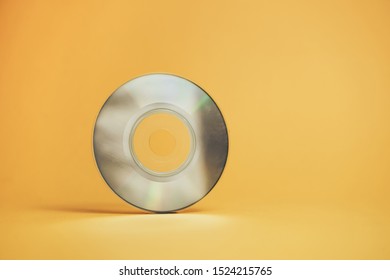 Close Up Beautiful Old Mini Disk On Yellow Background.