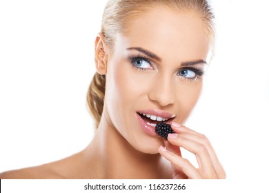 Close Up Of Beautiful Woman Eating Blackberries On White