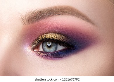 Close Up Of Beautiful Woman Eye With Multicolored Smokey Eyes Makeup. Modern Fashion Make Up. Studio Shot