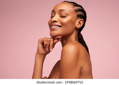 Close up of beautiful woman with hand on chin. African american woman with perfect healthy skin. - Powered by Shutterstock