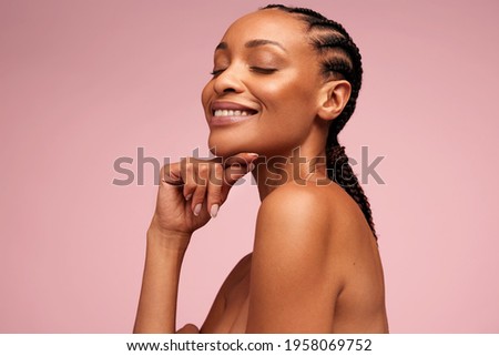 Close up of beautiful woman with hand on chin. African american woman with perfect healthy skin.