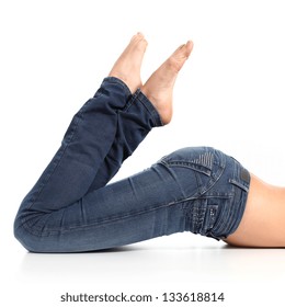 Close Up Of A Beautiful Woman Legs With Jeans And Barefoot Isolated On A White Background