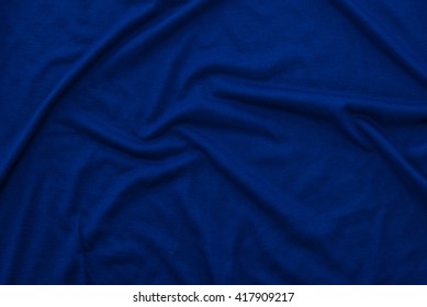 Close Up Of Beautiful Wrinkle Navy Blue Color Bedsheet Fabric Texture.