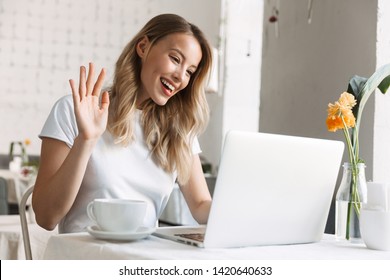 Close Up Of A Beautiful Young Blonde Woman At The Cafe Indoors, Having Videocall On Laptop