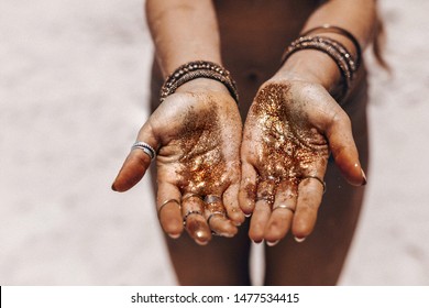 Close Up Of Beautiful Young Woman Arms With Tanned Skin Holding Gold Blossoms 