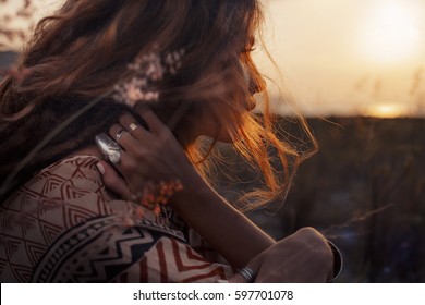 close up of beautiful young woman at sunset