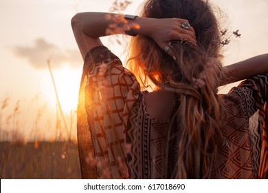 close up of beautiful young woman at sunset