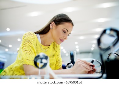 Close Up Of Beautiful Young Woman In A Tech Store, Exploring New Smart Watch.