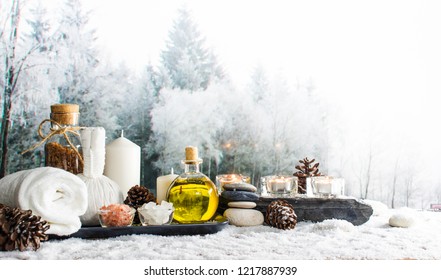 Close up of beauty and fashion concept with spa setting for wellness center. Beautiful composition of spa cosmetic products concept, massage and treatment in winter with snowflake and pine cones
