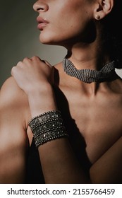 Close Up Beauty Portrait Of A Beautiful Young Woman Wearing A Brilliant Necklace And A Silver Shimy Bracelet On Her Nude Skin