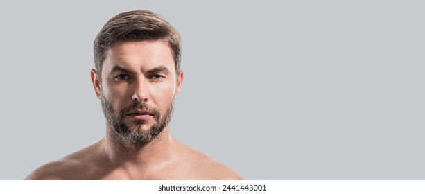 Close up beauty portrait of satisfied man after facial cream. Attractive brunet guy touching skin. Men model face with beard and modern haircut. Banner for header, copy space. Poster for web design. - Powered by Shutterstock