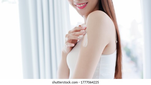 Close Up Of Beauty Skin Care Woman Applying Body Lotion On Arm And Shoulder At Home