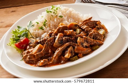 Close up of Beef goulash stroganoff on rustic background on a white plate