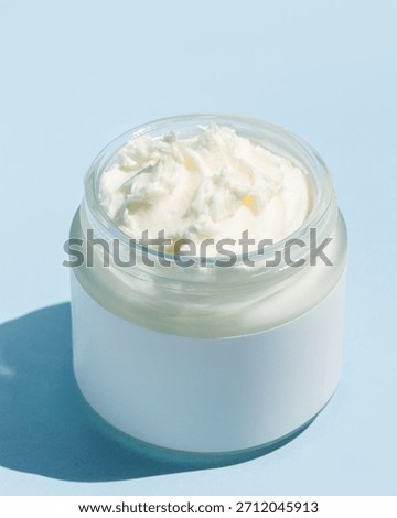 Close up of beef tallow balm texture on blue background =