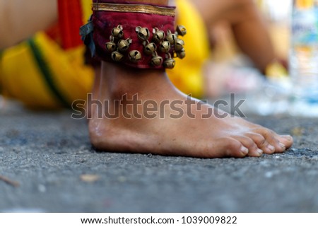 Close up bell on a devotee foot during Thaipusam. Thaipusam is a festival celebrated by the Tamil community on the full moon in the Tamil month of Thai.
