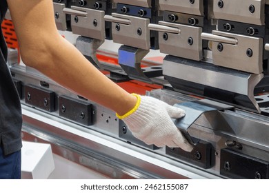 Close up the bending machine operator hold the sheet metal parts. The sheet metal working operation by skill operator. - Powered by Shutterstock