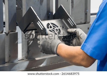 Close up the bending machine operator hold the sheet metal parts with rubber glove. The sheet metal working operation by skill operator.