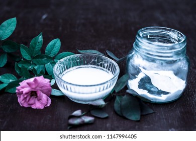 Close Up Of Best And Effective Home Remedy For Acne I.e. Baking Soda Mixed With Water Into A Thick Paste.On Wooden Surface With Rosa Flower.