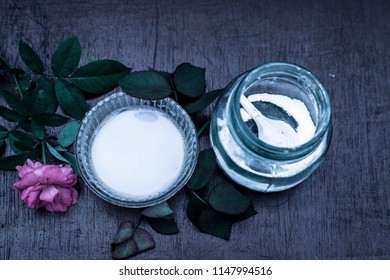 Close Up Of Best And Effective Home Remedy For Acne I.e. Baking Soda Mixed With Water Into A Thick Paste.On Wooden Surface With Rosa Flower.