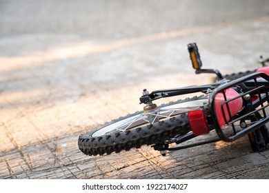 Close Up Of Bicycle Falling On The Ground Under Sunlight. Selective Focus On Hex Nut. Accident And Bike Safety. Learning To Bike Bicycle. No People. Rust On The Back Wheel.
