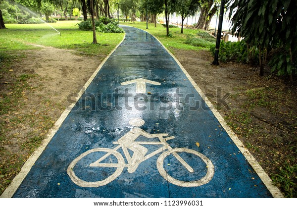Close up bicycle\
sign on wet public park\
road