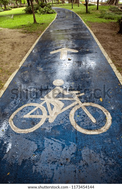 Close up bicycle\
sign on wet public park\
road