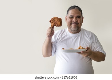 Close up Big happy fat man eating fried chicken for diet food concept  