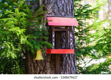 Close up of big red nesting box on a tree in the summer forest