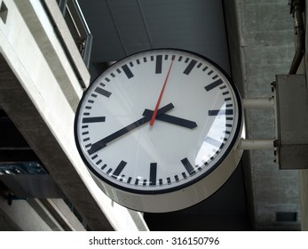 close up big round shape electronics clock show time three o'clock forty minutes on clock face hanging on concrete pole of sky train station, analog clock for check time when traveling in the city