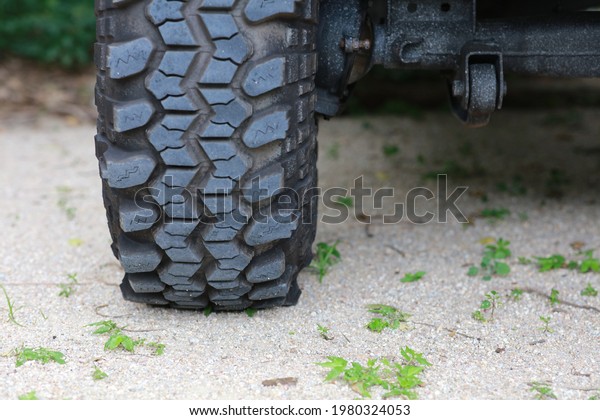 Close up of big tire of raly 4 wheel drive ,\
adventure vehicle