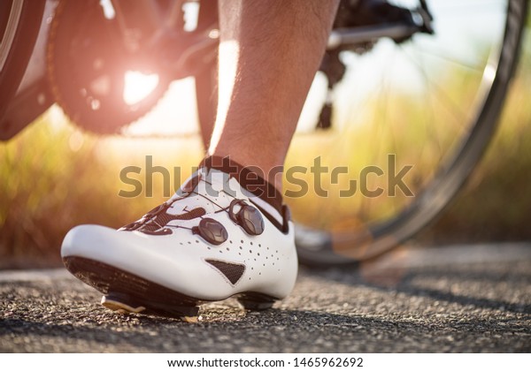 Close up bike shoes ready for cycling\
outdoors. Sports and outdoor activities\
concept.